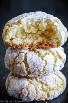 three powdered sugar cookies stacked on top of each other