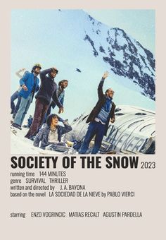 the poster for society of the snow shows several people standing in front of a snowy mountain