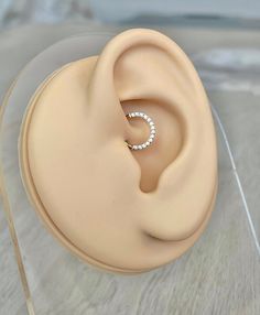 a close up of a fake ear with a ring in it's middle on a table