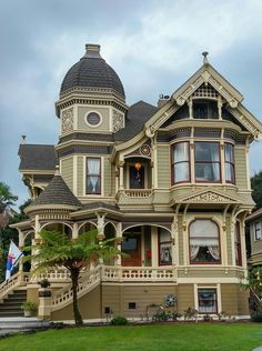 an old victorian style house on a cloudy day with stairs leading up to the second floor