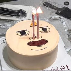 a birthday cake with a face drawn on it