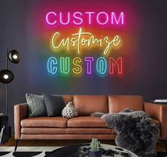 a living room filled with furniture and a neon sign on the wall above it that says custom