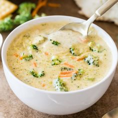 a white bowl filled with broccoli cheese soup