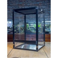 a glass box sitting on top of a wooden floor