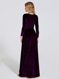 a woman in a long purple dress is looking back at the camera and she has her hands on her hips