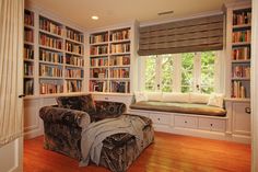 a living room filled with lots of book shelves next to a window covered in books