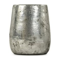 a silver vase sitting on top of a white table