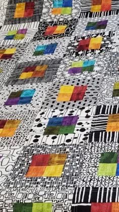 a quilt made with different colored squares on it