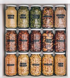 jars filled with different types of beans and nuts in each one's own container