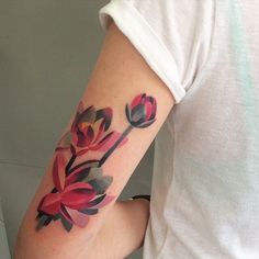 a woman's arm with flowers painted on it and an arrow in the middle