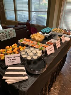 a buffet table filled with different types of food and desserts on top of it