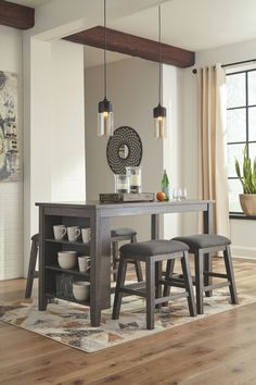 a dining room table with chairs and a bench