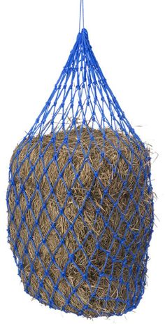 a blue net hanging from the side of a hay bale filled with straw on a white background