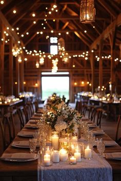 a long table with candles and flowers on it