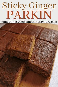 sliced brownies sitting on top of a wooden cutting board with text overlay that reads sticky ginger parkin