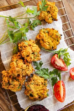 some food is sitting on a wire rack with tomatoes and parsley next to it