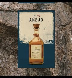 a bottle of arganes sitting on top of a rock next to a sign