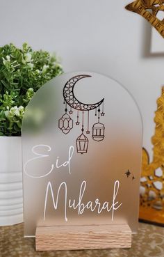 a clear acrylic sign that says eid mubarak