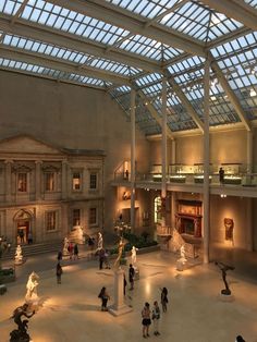 the inside of a museum with people walking around