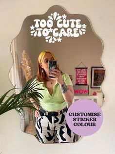 a woman taking a selfie in front of a mirror with the words too cute to care on it