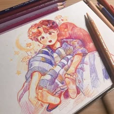 colored pencils are next to a drawing of a boy and girl hugging each other