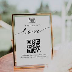 a sign that says capture the love with a qr code in front of it