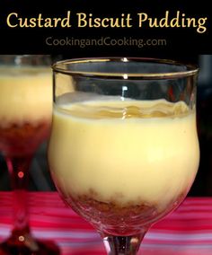 a glass filled with pudding sitting on top of a red and white striped table cloth