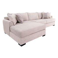 a white sectional couch with pillows on it