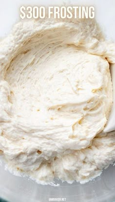 a bowl filled with whipped cream sitting on top of a table