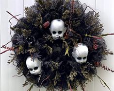 a wreath with two skulls and plants on it