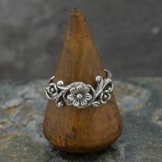 "An intricate silver ring with flower on a vine design. Oxidised sterling silver to highlight the details.  Wide range of sizes are available - chose when ordering - please see advice regarding sizing.  *Select ring size when ordering - US sizes are listed - l *See ring size chart if unsure  *Buyer responsible for postage if exchange in size required  *Comes Gift boxed  *Ships direct from Edinburgh, Scotland *Supports a small artisan business \"Happiness radiates like the fragrance from a flower and draws all good things towards you.\" Maharishi Mahesh Yogi We are very happy to exchange, however postal cost for exchange is the buyers responsibility. For accurate results we recommend going to a local jewellers to ask for a fitting. If you have bought this ring and would like to exchange it Sterling Silver Flower Rings, Oxidised Silver Ring, Maharishi Mahesh Yogi, Ring Size Chart, Oxidized Silver Rings, Boho Jewellery, Nature Ring, Vine Design, Edinburgh Scotland