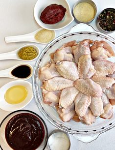 the ingredients for chicken wings are arranged in bowls