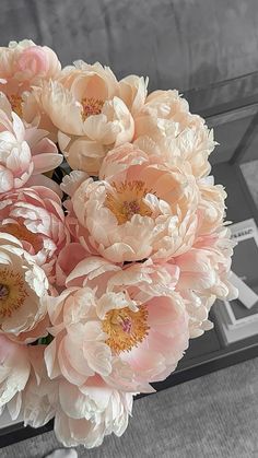 a bouquet of pink flowers sitting on top of a table