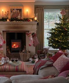 a living room filled with lots of furniture and a fire place surrounded by christmas decorations