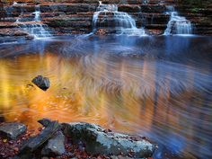 an image of a waterfall in the fall