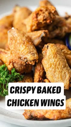 fried chicken wings on a plate with dipping sauce and parsley garnishes