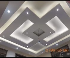 an empty room with some lights on the ceiling and recessed lighting in the ceiling