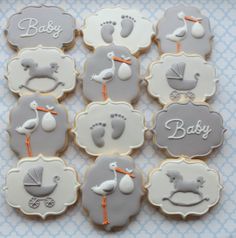 some cookies that are in the shape of baby feet and ones with names on them