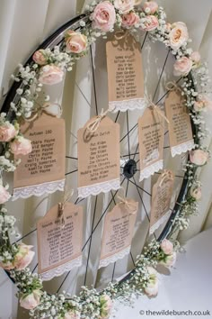 an image of a bicycle wheel with tags attached to the wheels and flowers around it