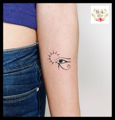 a woman's arm with an eye tattoo on the left side of her arm