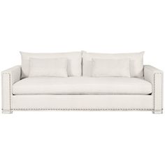 a white couch with four pillows on it's back and one arm facing the camera