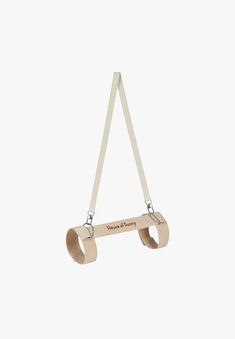 a wooden toy hanging from the side of a white wall with two straps attached to it