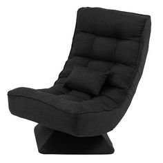 a black reclining chair with pillows on it's back and footrests