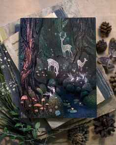 three cards with deer in the woods surrounded by pine cones