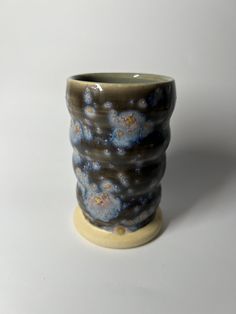 a ceramic vase sitting on top of a white table