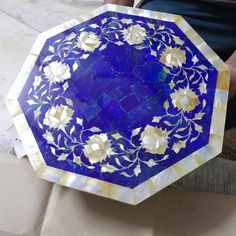 a blue and white plate sitting on top of a piece of paper next to a bag