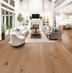 a living room filled with furniture and a fire place in the middle of an open floor plan