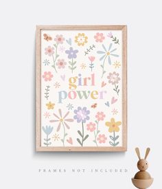 the girl power print is displayed next to a wooden toy and an empty vase with flowers on