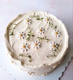 a cake with white frosting and flowers on it