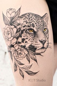 a woman's thigh with a leopard and flowers on it